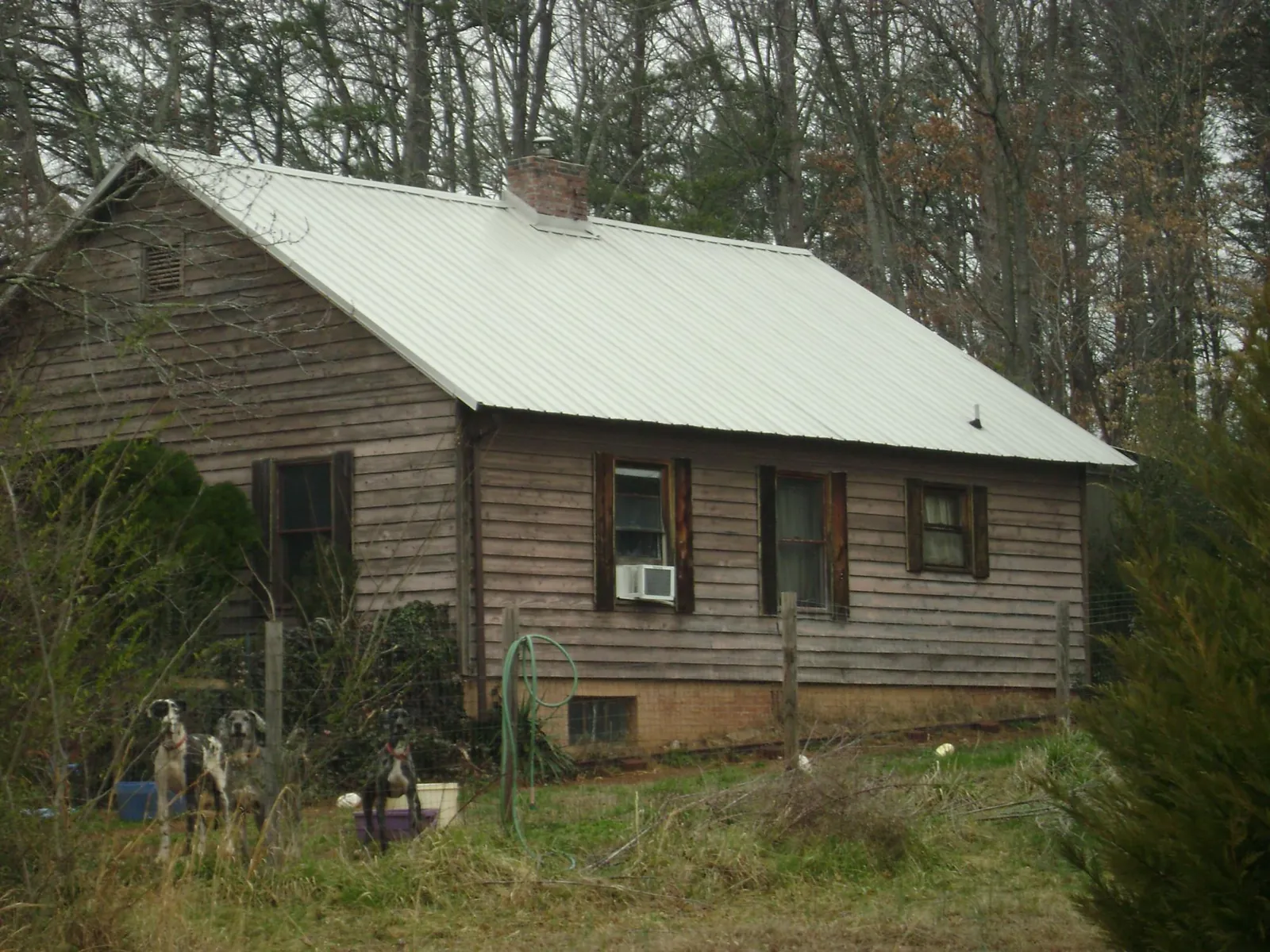 White metal roof on an old wood sided farmhouse, from a Metal Roof Installation job in Monroe